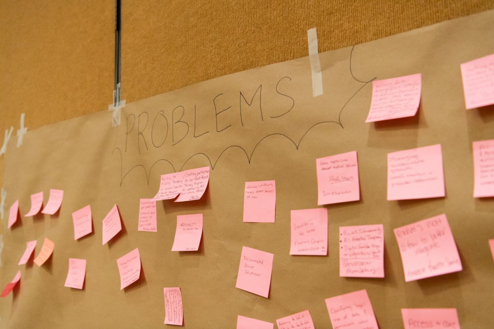 The Problem Wall at HealthAI 2026, covered in pink sticky notes